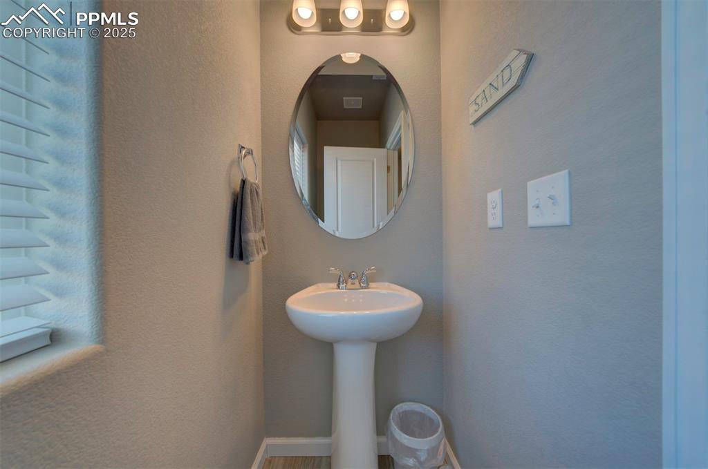 4151 Jericho Loop Colorado Springs, CO 80916 - Photo 18 of 34 a bathroom with a sink and a mirror