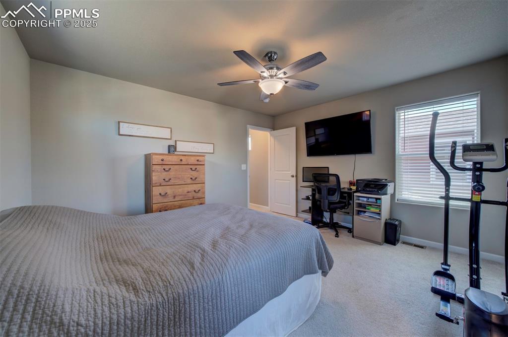 4151 Jericho Loop Colorado Springs, CO 80916 - Photo 21 of 34 a bedroom with a bed and a flat screen tv