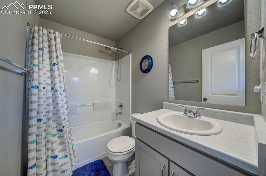 4151 Jericho Loop Colorado Springs, CO 80916 - Photo 26 of 34 a bathroom with a sink a toilet and shower