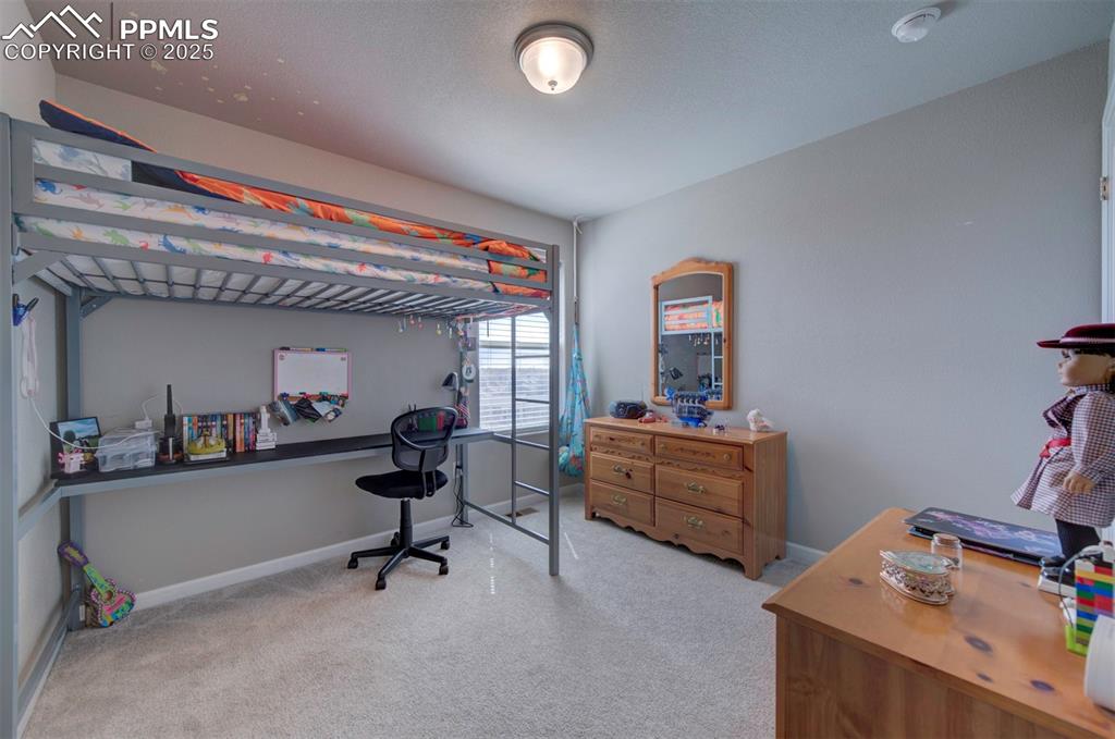 4151 Jericho Loop Colorado Springs, CO 80916 - Photo 30 of 34 a view of a workspace with furniture and a window
