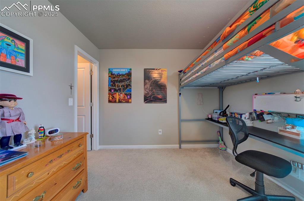 4151 Jericho Loop Colorado Springs, CO 80916 - Photo 31 of 34 a bedroom with a bed and furniture