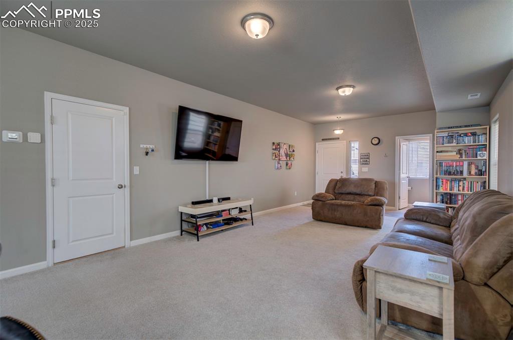 4151 Jericho Loop Colorado Springs, CO 80916 - Photo 5 of 34 a living room with furniture and a flat screen tv