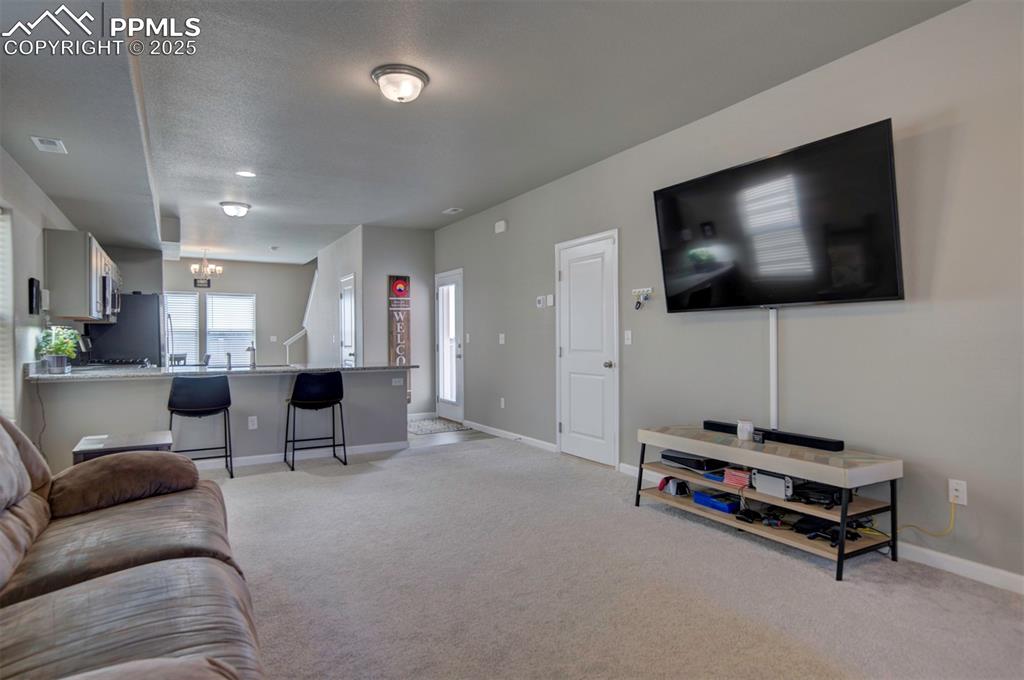 4151 Jericho Loop Colorado Springs, CO 80916 - Photo 6 of 34 a living room with furniture and a flat screen tv