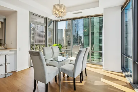 a view of a dining room with furniture wooden floor and chandelier