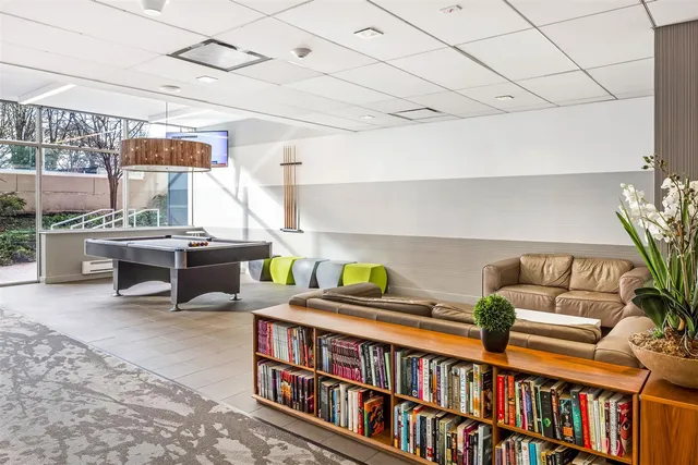a room with furniture lots of books and a book shelf