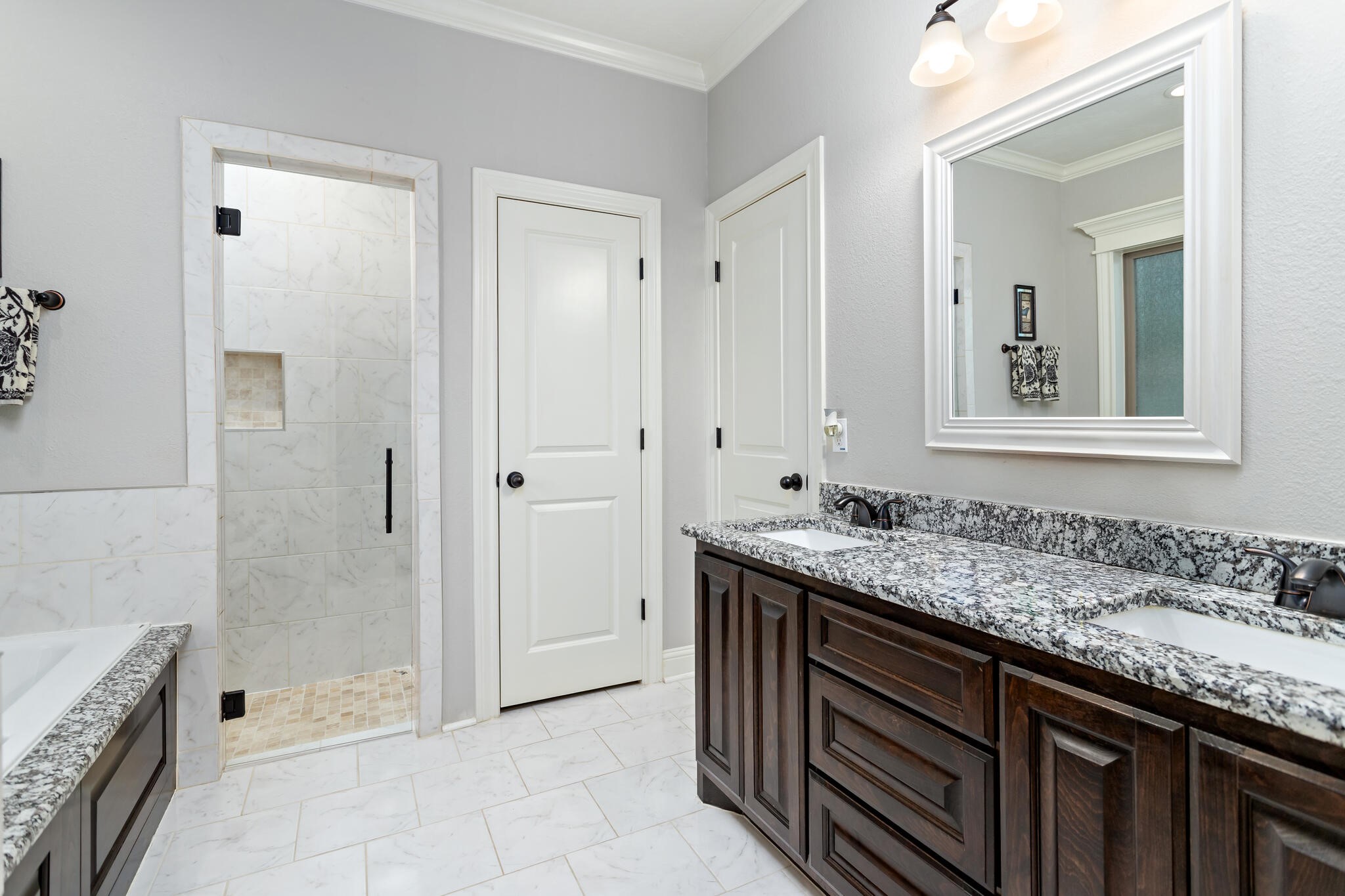 3210 Ethan Symone Street Beaumont, TX 77705 - Photo 19 of 33 a bathroom with a granite countertop sink a mirror and a bathtub