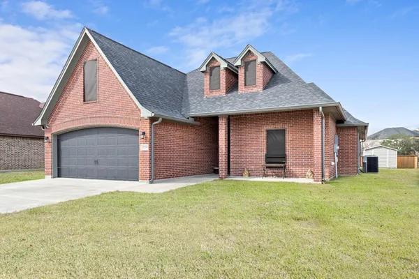 a front view of a house with a yard