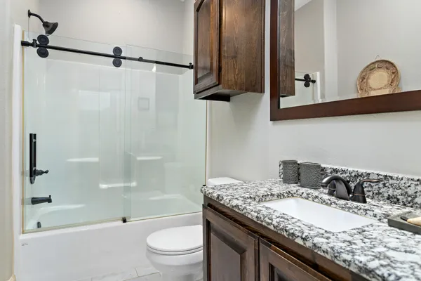 a bathroom with a shower and a toilet