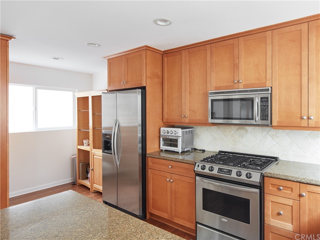 210 Whiting Street, Unit C El Segundo, CA 90245 - Photo 13 of 27 a kitchen with stainless steel appliances granite countertop a refrigerator stove and microwave