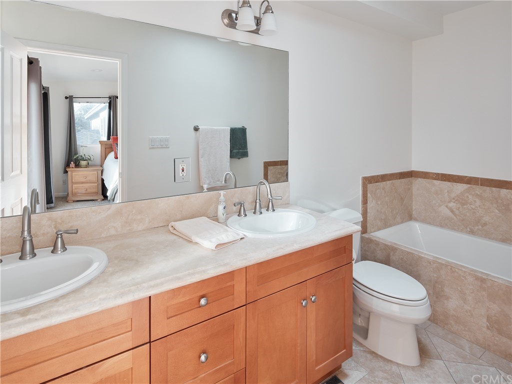 210 Whiting Street, Unit C El Segundo, CA 90245 - Photo 17 of 27 a bathroom with a granite countertop sink a toilet and a bathtub