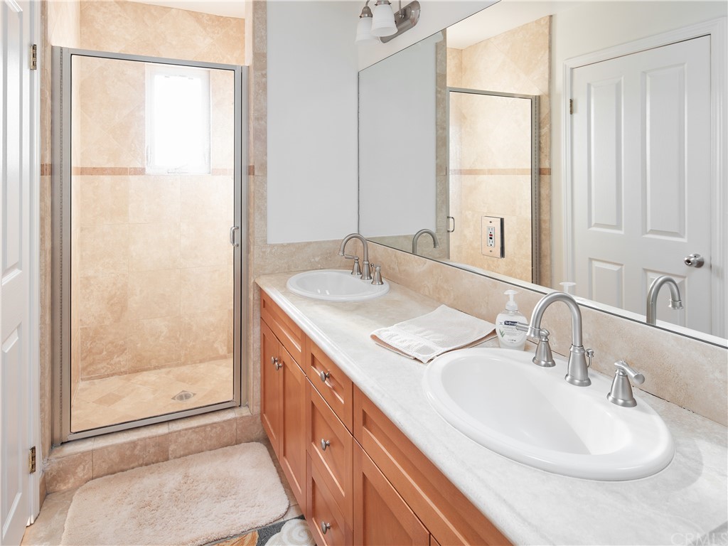 210 Whiting Street, Unit C El Segundo, CA 90245 - Photo 18 of 27 a bathroom with a double vanity sink and a mirror