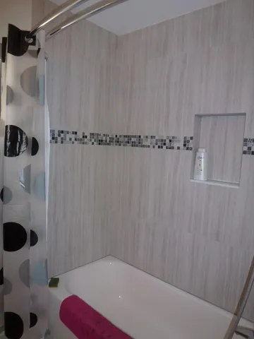 a bathroom with a shower and a sink