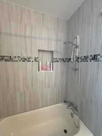 a bathroom with a shower and a tub