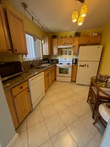 a kitchen with cabinets a sink and appliances