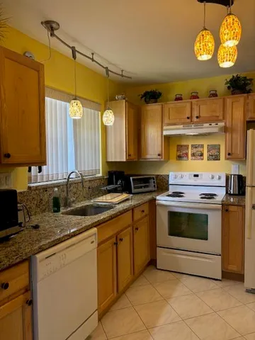 a kitchen with stainless steel appliances a stove a sink and a microwave