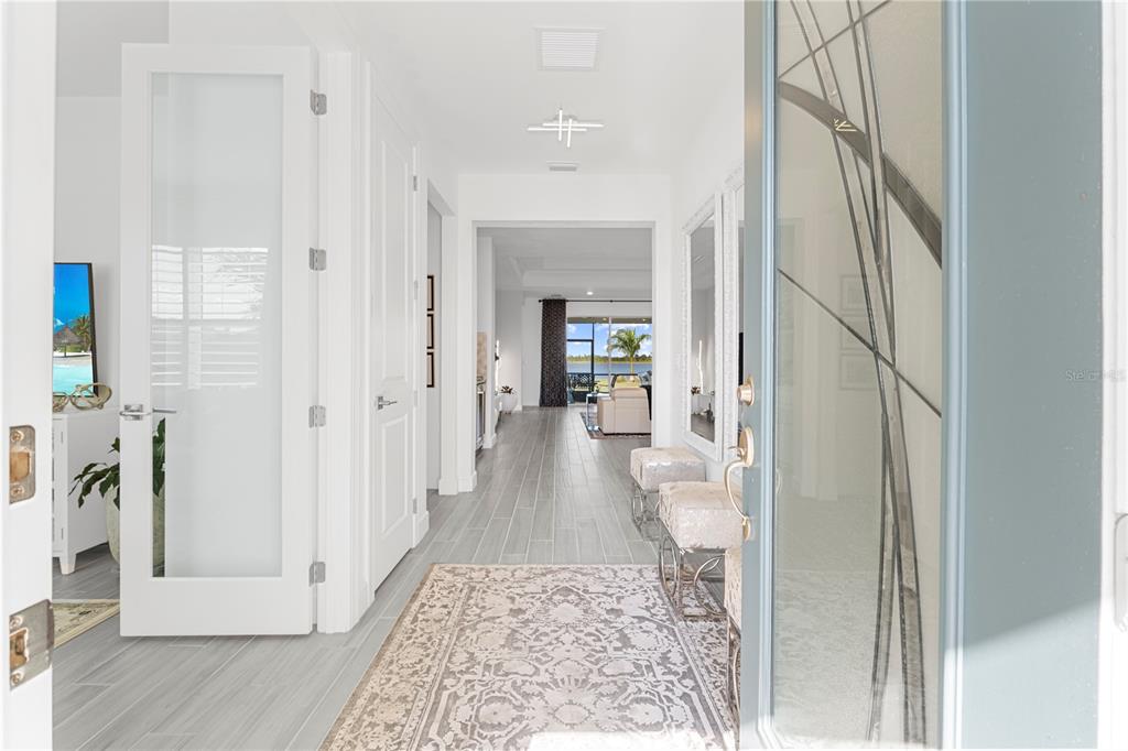 42363 Edgewater Drive Punta Gorda, FL 33982 - Photo 13 of 72 a view of a hallway with wooden floor and staircase