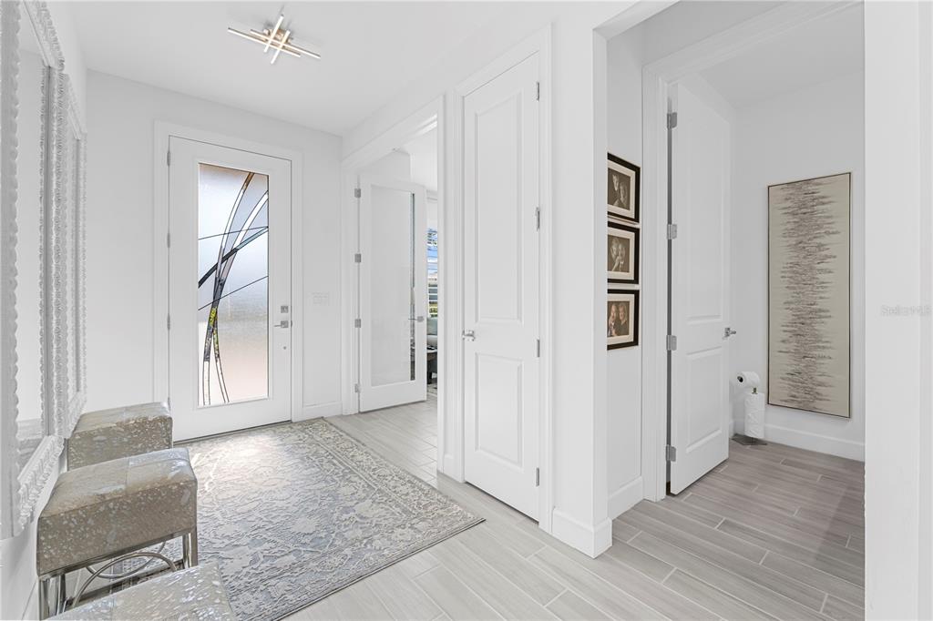 42363 Edgewater Drive Punta Gorda, FL 33982 - Photo 15 of 72 a view of a hallway with wooden floor and cabinet
