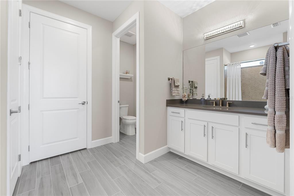 42363 Edgewater Drive Punta Gorda, FL 33982 - Photo 23 of 72 a spacious bathroom with a granite countertop sink and a mirror
