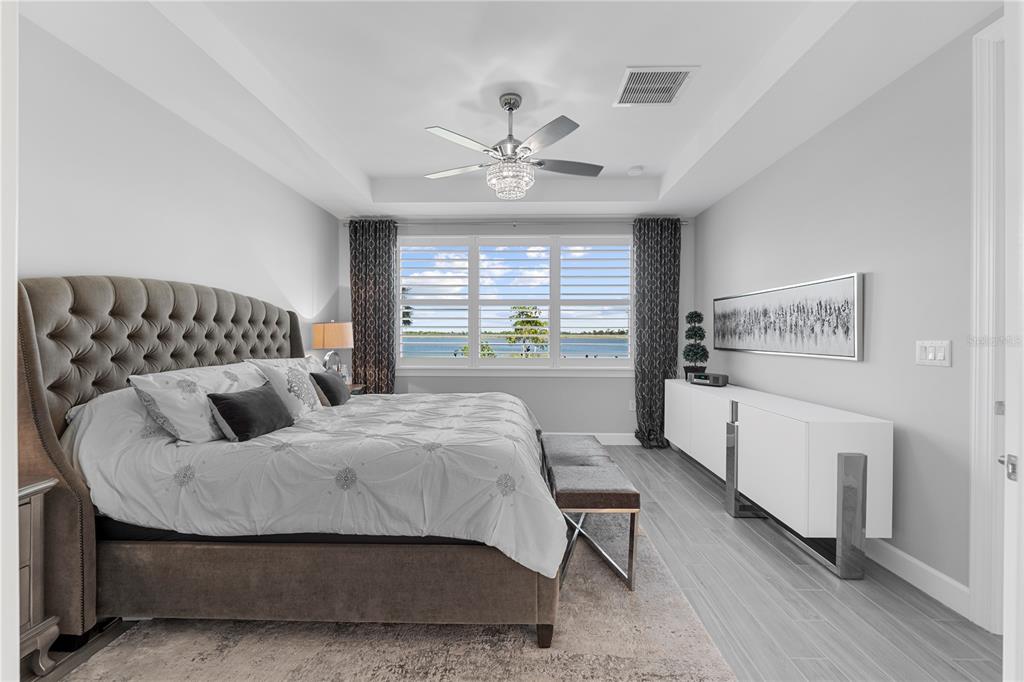 42363 Edgewater Drive Punta Gorda, FL 33982 - Photo 26 of 72 a bedroom with a bed and wooden floor