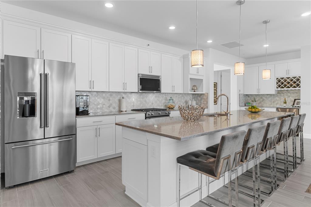 42363 Edgewater Drive Punta Gorda, FL 33982 - Photo 8 of 72 a kitchen with stainless steel appliances granite countertop a refrigerator a stove a sink and white cabinets