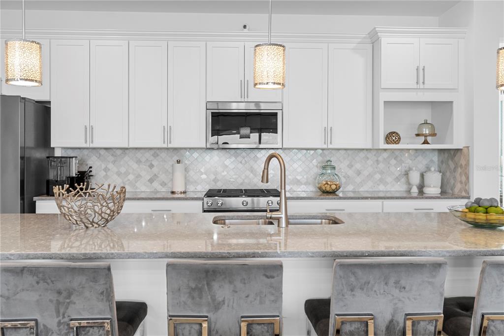 42363 Edgewater Drive Punta Gorda, FL 33982 - Photo 10 of 72 a kitchen with stainless steel appliances granite countertop a coffee maker on white granite countertops and cabinets