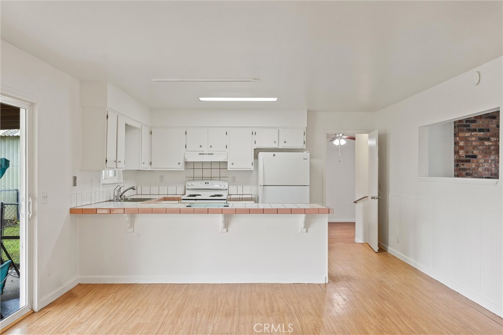 4229 Caballo Way Chico, CA 95973 - Photo 18 of 42 a view with kitchen island with stainless steel appliances granite countertop a stove and a refrigerator