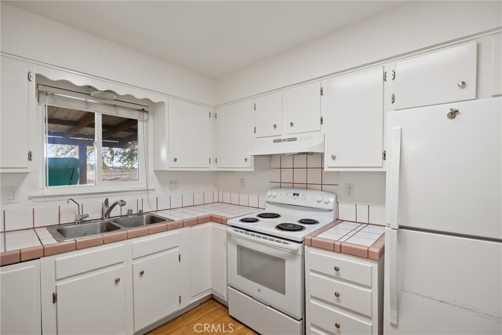 4229 Caballo Way Chico, CA 95973 - Photo 21 of 42 a kitchen with cabinets appliances a sink and a window