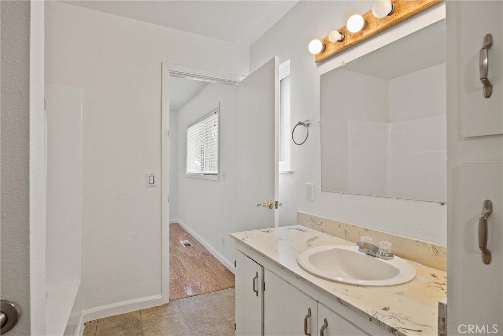 4229 Caballo Way Chico, CA 95973 - Photo 32 of 42 a bathroom with a granite countertop sink and a mirror