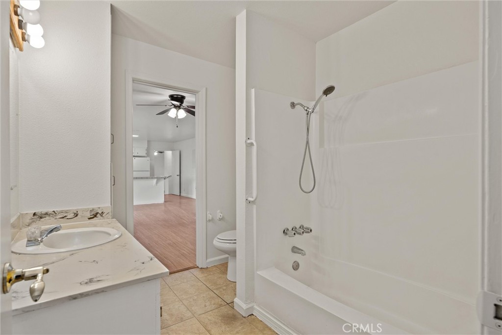 4229 Caballo Way Chico, CA 95973 - Photo 35 of 42 a bathroom with a granite countertop sink a mirror and a bathtub