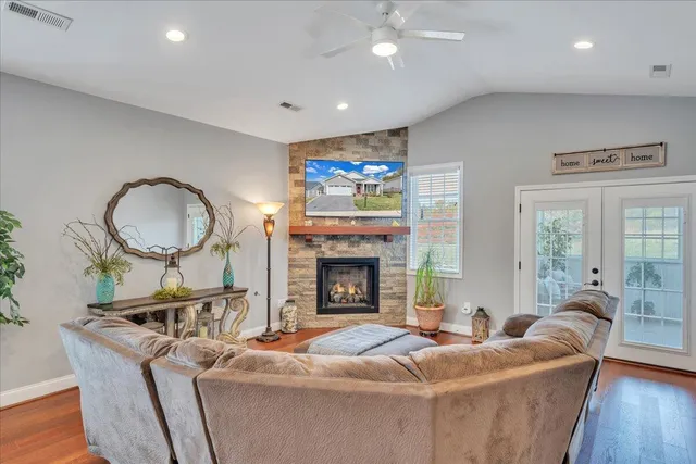 a living room with furniture and a potted plant