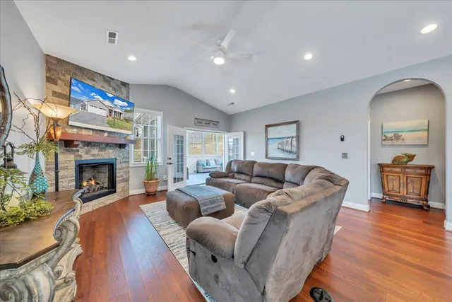 a view of a hallway with wooden floor and closet