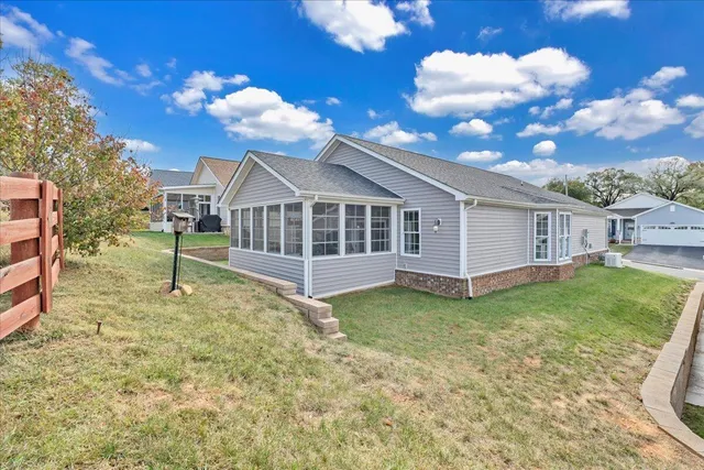 a large kitchen with stainless steel appliances granite countertop a refrigerator a sink dishwasher a stove with white cabinets and wooden floor