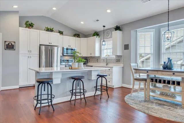 a living room with furniture a fireplace and wooden floor