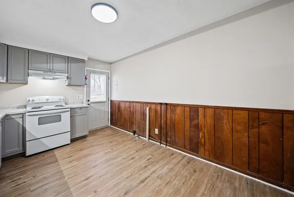 a kitchen with wooden cabinets and white appliances