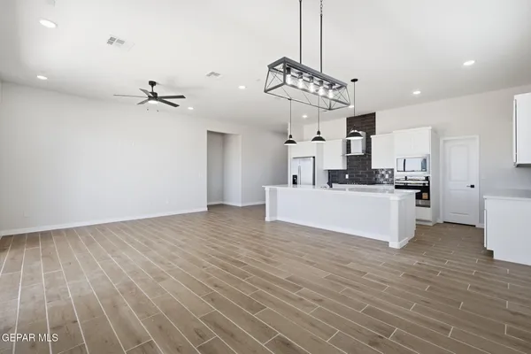 a view of a kitchen with a sink stainless steel appliances and cabinets