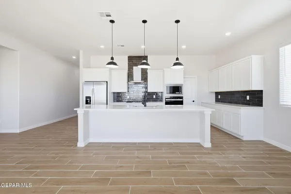 a view living room with stainless steel appliances kitchen island granite countertop furniture