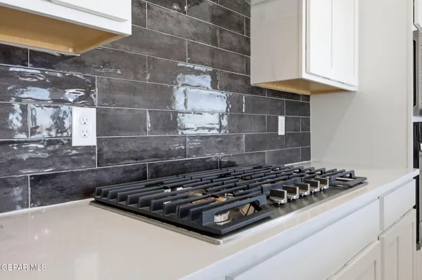 a stove top oven sitting inside of a kitchen