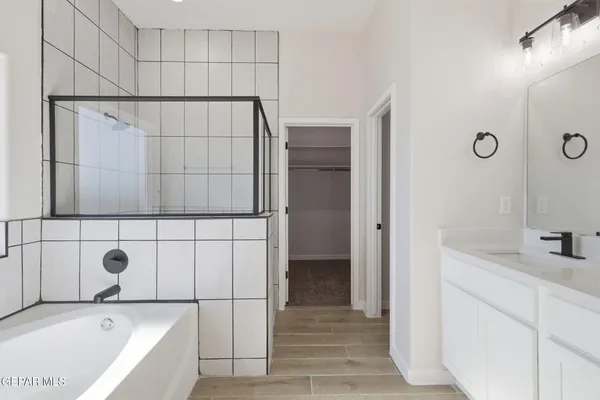 a bathroom with a tub a sink and shower