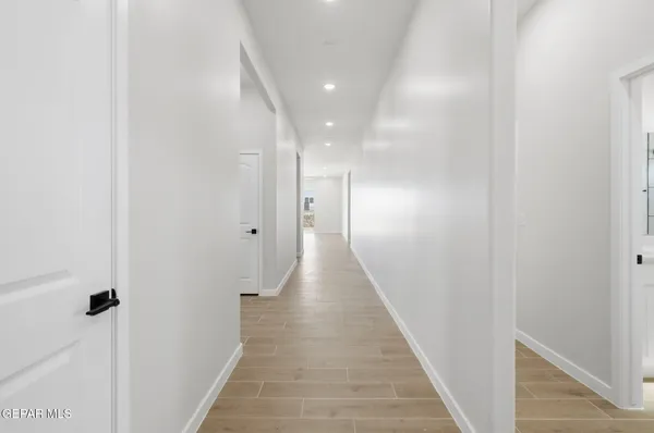 a view of a hallway with wooden floor