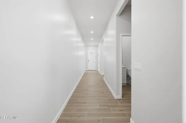 a view of a hallway with wooden floor