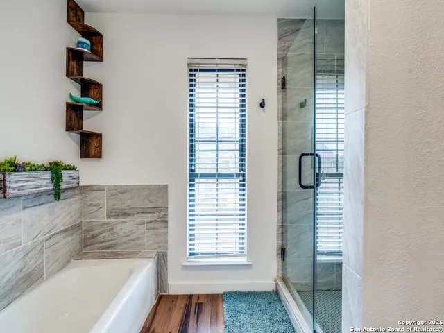 a bathroom with a bathtub and shower