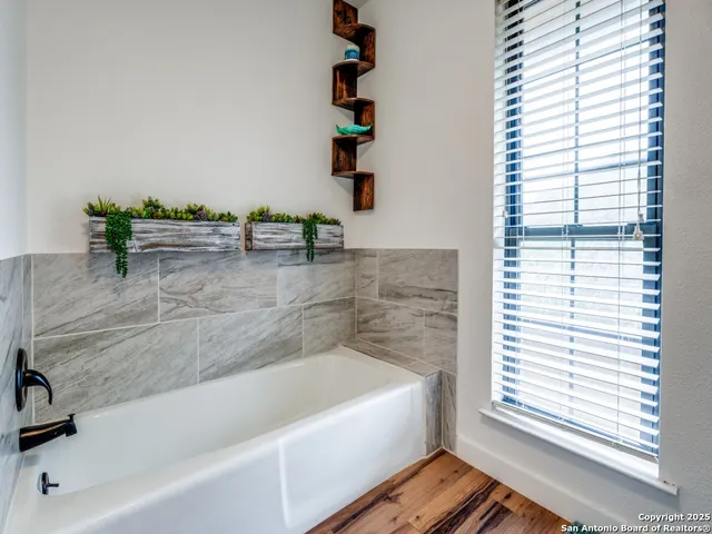 a bathroom with a bathtub and shower