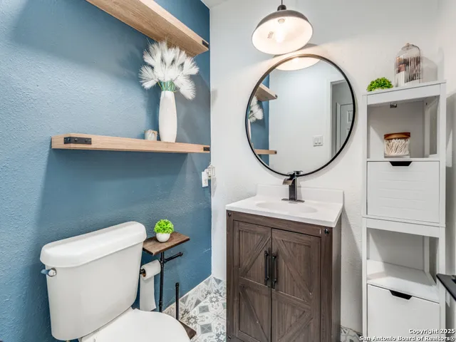 a bathroom with a toilet sink and mirror