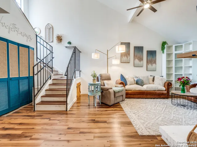 a living room with furniture and wooden floor