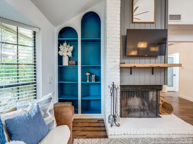a living room with furniture and a fireplace