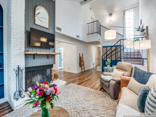 a living room with furniture and a fireplace
