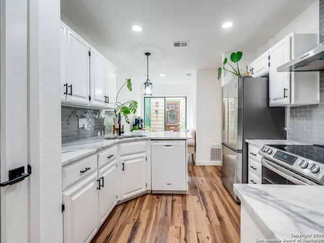 a kitchen with cabinets appliances and a counter space