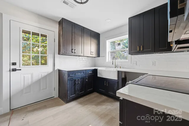 a kitchen with a sink cabinets and window