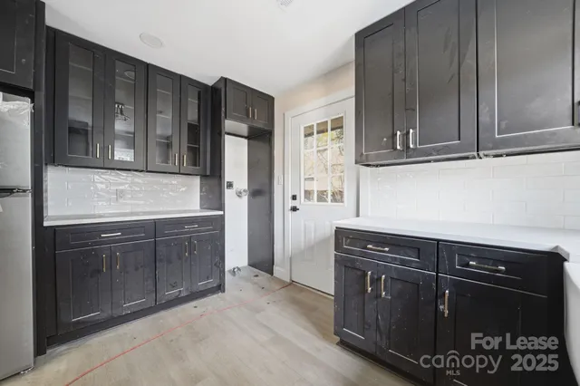a kitchen with granite countertop cabinets and black appliances