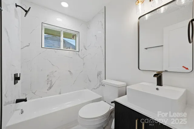 an empty room with wooden floor ceiling fan and windows